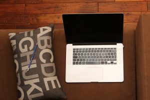 photo of laptop on sofa to illustrate how not to preserve laptop battery life