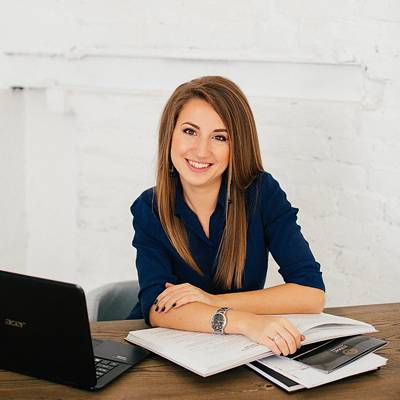 young woman with laptop and books