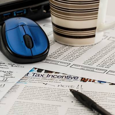 photo of essential tax itmes - notes, computer mouse and coffee